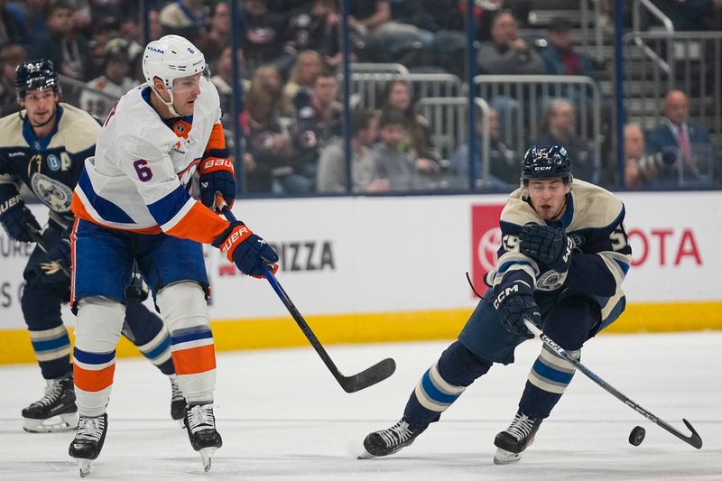 Oct 30, 2024; Columbus, Ohio, USA; Columbus Blue Jackets right wing Yegor Chinakhov (59) deflects a pass from New York Islanders defenseman Ryan Pulock (6) in the first period at Nationwide Arena. Mandatory Credit: Samantha Madar-Imagn Images