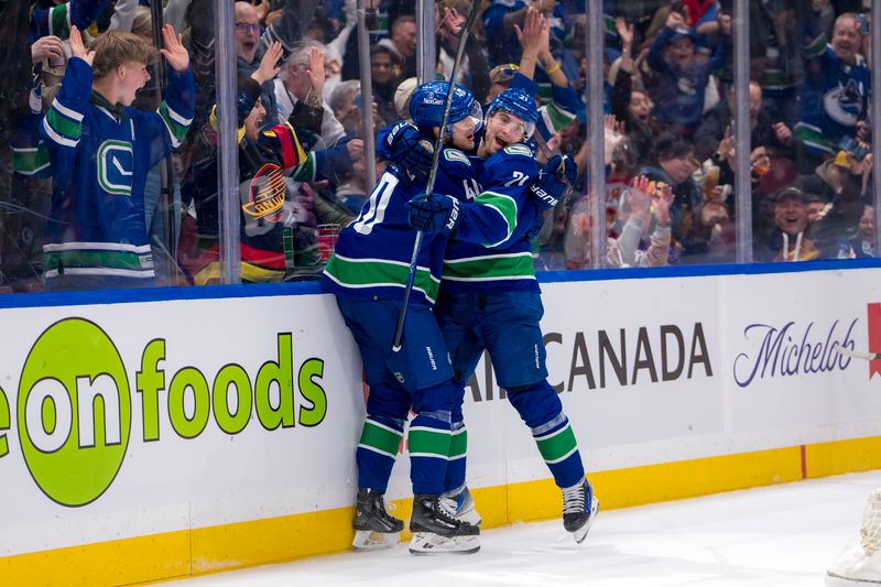 Apr 16, 2024; Vancouver, British Columbia, CAN;  Vancouver Canucks forward Elias Pettersson (40) and forward Nils Hoglander (21) celebrate Hoglander’s goal against the Calgary Flames in the first period at Rogers Arena. Mandatory Credit: Bob Frid-USA TODAY Sports