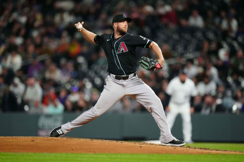 Apr 9, 2024; Denver, Colorado, USA; Arizona Diamondbacks starting pitcher Merrill Kelly (29) delivers a pitch in the fifth inning against the Colorado Rockies at Coors Field. Mandatory Credit: Ron Chenoy-USA TODAY Sports