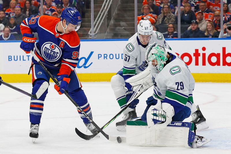 Apr 13, 2024; Edmonton, Alberta, CAN; Vancouver Canucks goaltender Casey DeSmith (29) makes a save on  on Edmonton Oilers forward Ryan Nugent-Hopkins (93) during the first period at Rogers Place. Mandatory Credit: Perry Nelson-USA TODAY Sports