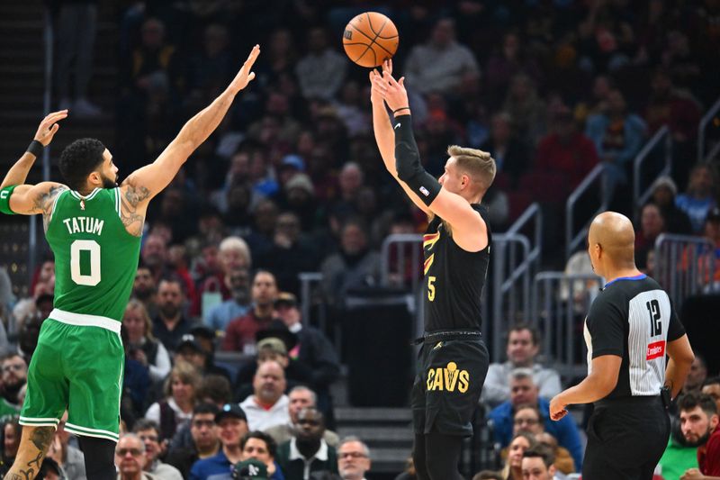 CLEVELAND, OHIO - FEBRUARY 04: Sam Merrill #5 of the Cleveland Cavaliers shoots over Jayson Tatum #0 of the Boston Celtics during the second quarter at Rocket Mortgage Fieldhouse on February 04, 2025 in Cleveland, Ohio. NOTE TO USER: User expressly acknowledges and agrees that, by downloading and or using this photograph, User is consenting to the terms and conditions of the Getty Images License Agreement. (Photo by Jason Miller/Getty Images)