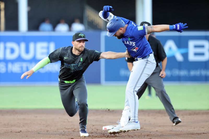 May 23, 2025; St. Petersburg, Florida, USA; Tampa Bay Rays second base Brandon Lowe (8) tags out Toronto Blue Jays outfielder Nathan Lukes (38) during the third inning at George M. Steinbrenner Field. Mandatory Credit: Kim Klement Neitzel-Imagn Images