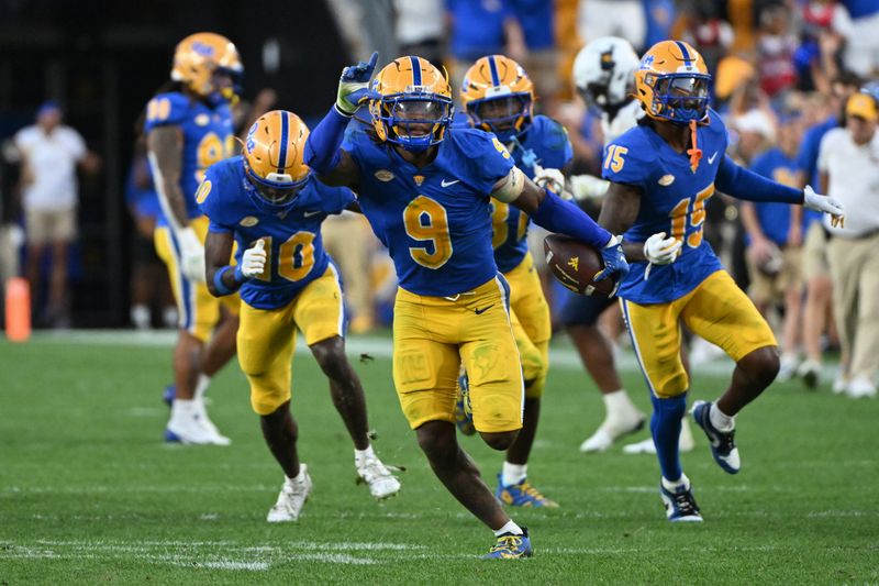 Sep 14, 2024; Pittsburgh, Pennsylvania, USA; Pittsburgh Panthers linebacker Kyle Louis celebrates after intercepting West Virginia Mountaineers quarterback Garrett Greene (6) in the fourth quarter at Acrisure Stadium. Mandatory Credit: Barry Reeger-Image Images