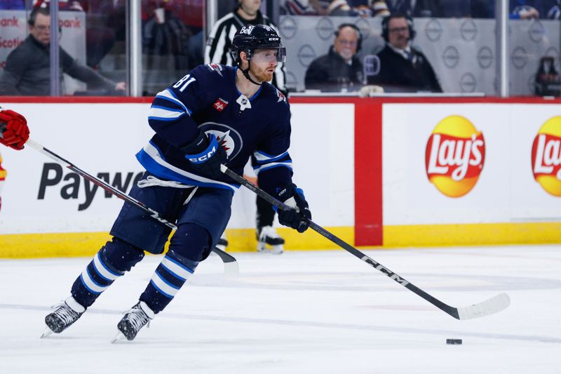 Jan 26, 2025; Winnipeg, Manitoba, CAN; Winnipeg Jets forward Kyle Connor (81) skates into the Calgary Flames zone during the second period at Canada Life Centre. Mandatory Credit: Terrence Lee-Imagn Images