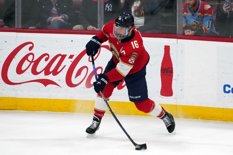 Jan 11, 2024; Sunrise, Florida, USA; Florida Panthers center Aleksander Barkov (16) passes the puck against the Los Angeles Kings during the first period at Amerant Bank Arena. Mandatory Credit: Jasen Vinlove-USA TODAY Sports