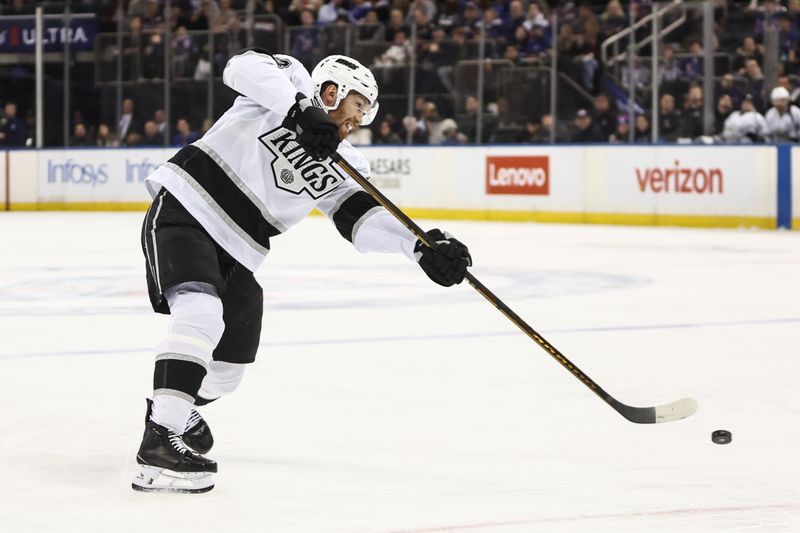 Dec 14, 2024; New York, New York, USA;  Los Angeles Kings defenseman Mikey Anderson (44) attempts a shot on goal in the first period against the New York Rangers at Madison Square Garden. Mandatory Credit: Wendell Cruz-Imagn Images