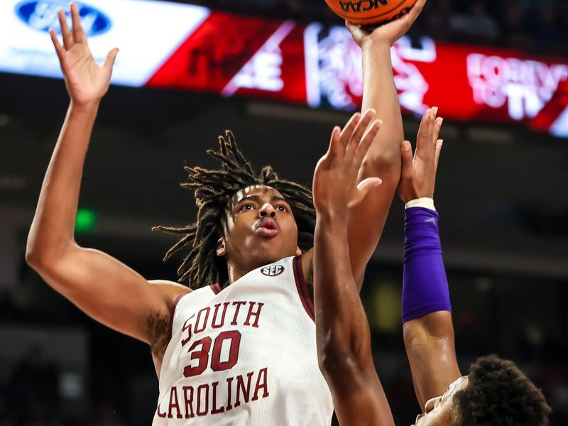 Feb 17, 2024; Columbia, South Carolina, USA; South Carolina Gamecocks forward Collin Murray-Boyles (30) shoots over LSU Tigers guard Jordan Wright (6) in the first half at Colonial Life Arena. Mandatory Credit: Jeff Blake-USA TODAY Sports