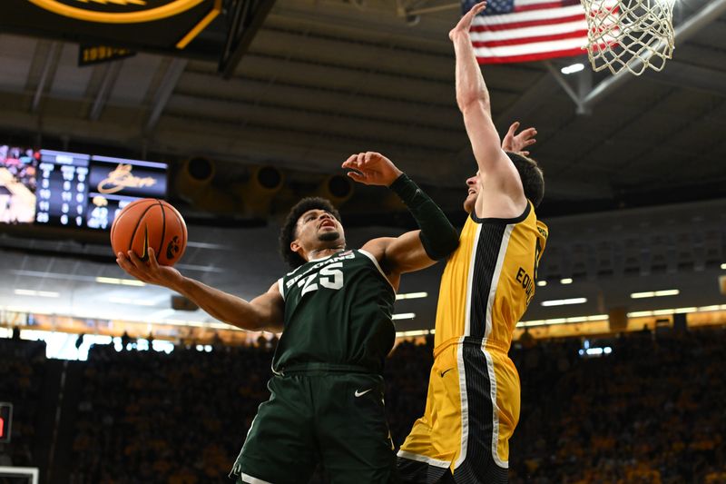 Feb 25, 2023; Iowa City, Iowa, USA; Michigan State Spartans forward Malik Hall (25) goes to the basket as Iowa Hawkeyes forward Filip Rebraca (0) defends during the first half at Carver-Hawkeye Arena. Mandatory Credit: Jeffrey Becker-USA TODAY Sports