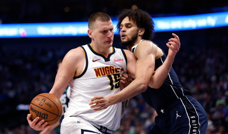 DALLAS, TX - MARCH 17: Nikola Jokic #15 of the Denver Nuggets drives to the basket and is met by Dereck Lively II #2 of the Dallas Mavericks in the first half at American Airlines Center on March 17, 2024 in Dallas, Texas. NOTE TO USER: User expressly acknowledges and agrees that, by downloading and or using this photograph, User is consenting to the terms and conditions of the Getty Images License Agreement. (Photo by Ron Jenkins/Getty Images)