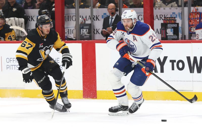 Dec 16, 2025; Pittsburgh, Pennsylvania, USA;  Edmonton Oilers center Leon Draisaitl (29) moves the puck against Pittsburgh Penguins right wing Rickard Rakell (67) during the first period at PPG Paints Arena. Mandatory Credit: Charles LeClaire-Imagn Images