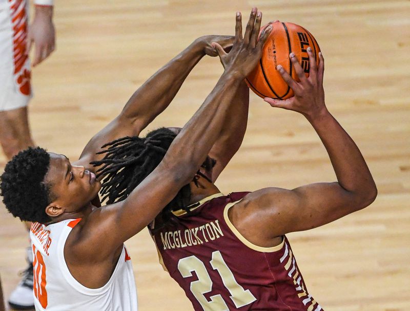 Jan 13, 2024; Clemson, South Carolina, USA; Clemson Tigers forward RJ Godfrey (10) fouls Boston College Eagles forward Devin McGlockton (21) during the first half at Littlejohn Coliseum. Mandatory Credit: Ken Ruinard-USA TODAY Sports