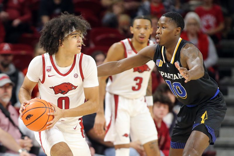 Dec 3, 2022; Fayetteville, Arkansas, USA; Arkansas Razorbacks guard Anthony Black (0) looks to pass in the first half as San Jose State Spartans guard Omari Moore (10) defends at Bud Walton Arena. Mandatory Credit: Nelson Chenault-USA TODAY Sports