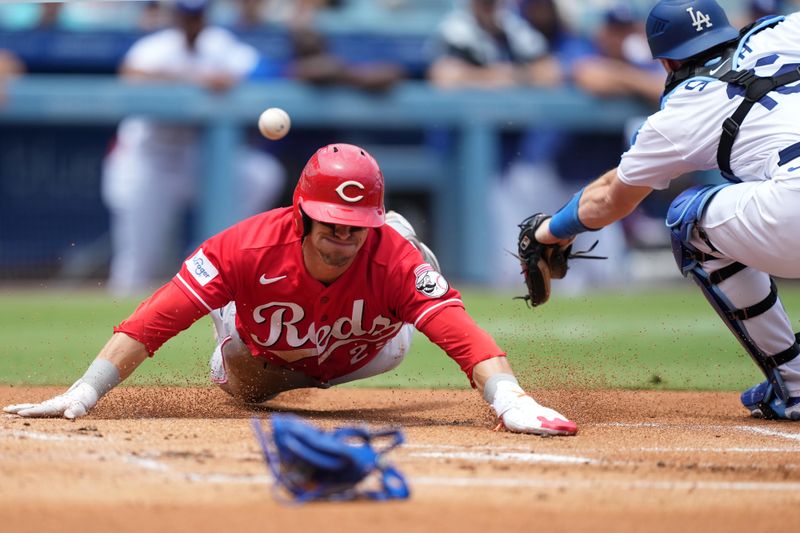 Jul 30, 2023; Los Angeles, California, USA; Cincinnati Reds center fielder TJ Friedl (29) slides into home plate to beat a throw to Los Angeles Dodgers catcher Will Smith (16) to score in the first inning at Dodger Stadium. Mandatory Credit: Kirby Lee-USA TODAY Sports