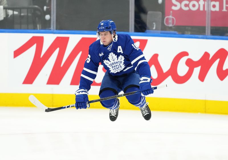 Oct 12, 2024; Toronto, Ontario, CAN; Toronto Maple Leafs right wing Mitch Marner (16) jumps during the warmup before a game against the Pittsburgh Penguins at Scotiabank Arena. Mandatory Credit: Nick Turchiaro-Imagn Images