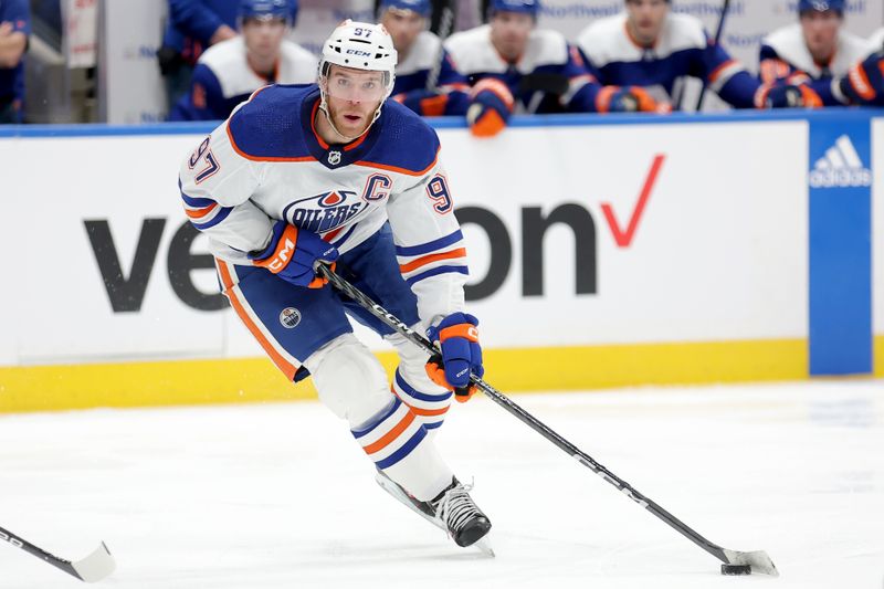 Dec 19, 2023; Elmont, New York, USA; Edmonton Oilers center Connor McDavid (97) controls the puck against the New York Islanders during the first period at UBS Arena. Mandatory Credit: Brad Penner-USA TODAY Sports