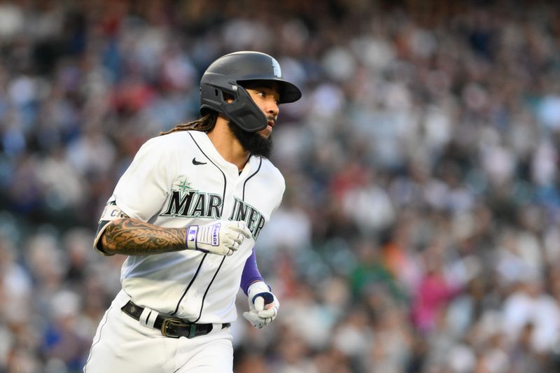 Sep 11, 2023; Seattle, Washington, USA; Seattle Mariners shortstop J.P. Crawford (3) runs towards first base after hitting a single against the Los Angeles Angels during the first inning at T-Mobile Park. Mandatory Credit: Steven Bisig-USA TODAY Sports