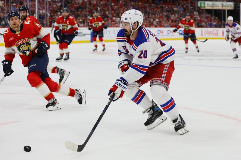 May 28, 2024; Sunrise, Florida, USA; New York Rangers left wing Chris Kreider (20) moves the puck against the Florida Panthers during the third period in game four of the Eastern Conference Final of the 2024 Stanley Cup Playoffs at Amerant Bank Arena. Mandatory Credit: Sam Navarro-USA TODAY Sports