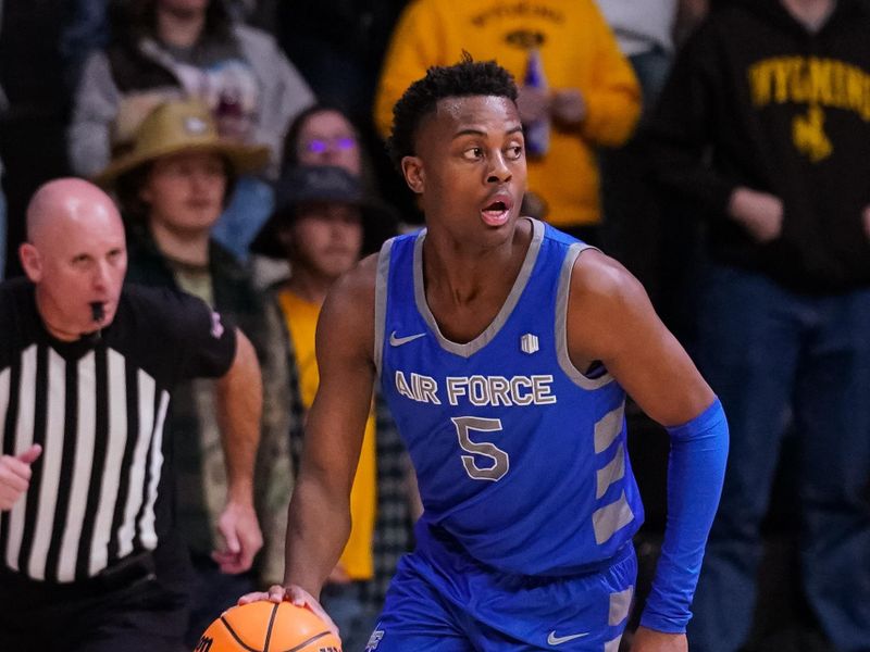 Feb 17, 2023; Laramie, Wyoming, USA; Air Force Falcons guard Ethan Taylor (5) dribbles against the Wyoming Cowboys during the first half at Arena-Auditorium. Mandatory Credit: Troy Babbitt-USA TODAY Sports