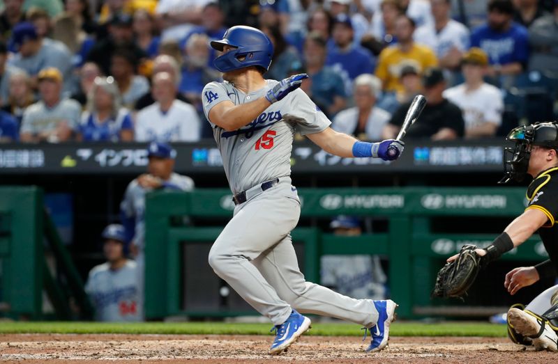 Jun 6, 2024; Pittsburgh, Pennsylvania, USA;  Los Angeles Dodgers catcher Austin Barnes (15) hits a single against the Pittsburgh Pirates during the fifth inning at PNC Park. Mandatory Credit: Charles LeClaire-USA TODAY Sports