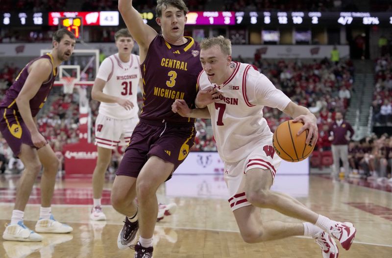 Dec 22, 2025; Madison, Wisconsin, USA; Wisconsin guard Andrew Rohde (7) drives past Central Michigan guard Jaxson Whitaker (3) during the second half of their game at the Kohl Center. Wisconsin beat Central Michigan 88-61. Mandatory Credit: Mark Hoffman-USA TODAY Network via Imagn Images