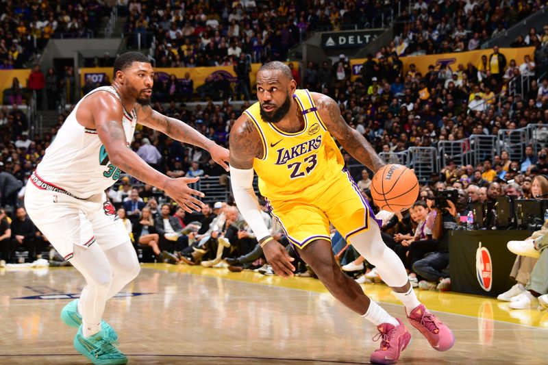LOS ANGELES, CA - NOVEMBER 13: LeBron James #23 of the Los Angeles Lakers handles the ball during the game against the Memphis Grizzlies on November 13, 2024 at Crypto.Com Arena in Los Angeles, California. NOTE TO USER: User expressly acknowledges and agrees that, by downloading and/or using this Photograph, user is consenting to the terms and conditions of the Getty Images License Agreement. Mandatory Copyright Notice: Copyright 2024 NBAE (Photo by Adam Pantozzi/NBAE via Getty Images)