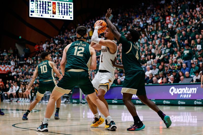 Mar 2, 2024; Fort Collins, Colorado, USA; Wyoming Cowboys guard Brendan Wenzel (1) looks to pass under pressure from Colorado State Rams forward Patrick Cartier (12) and guard Isaiah Stevens (4) in the second half at Moby Arena. Mandatory Credit: Isaiah J. Downing-USA TODAY Sports