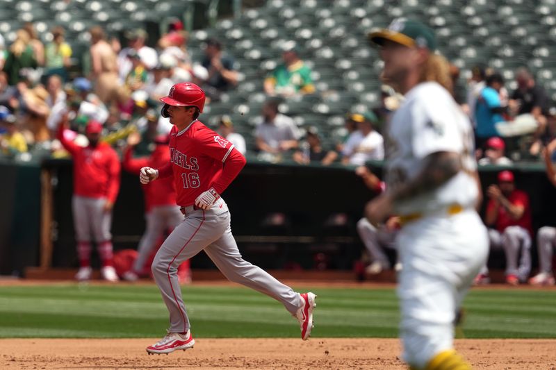 Jul 21, 2024; Oakland, California, USA; Los Angeles Angels center fielder Mickey Moniak (16) rounds the bases after hitting a home run against Oakland Athletics starting pitcher Joey Estes (foreground right) during the fifth inning at Oakland-Alameda County Coliseum. Mandatory Credit: Darren Yamashita-USA TODAY Sports