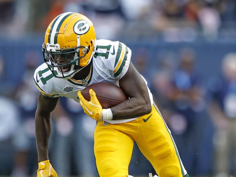 Green Bay Packers wide receiver Jayden Reed (11) rushes with the ball during the first half of an NFL football game against the Chicago Bears, Sunday, Sept. 10, 2023, in Chicago. (AP Photo/Kamil Krzaczynski)