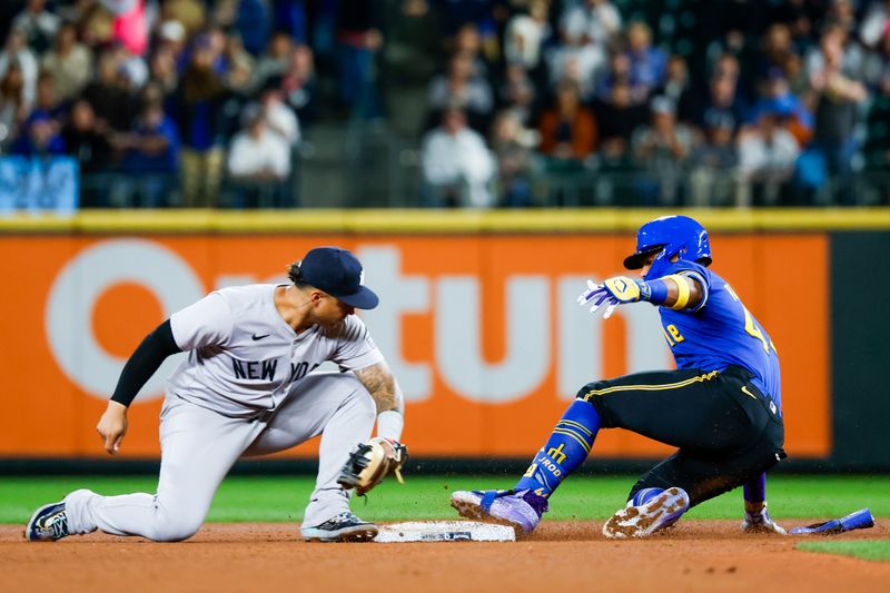 Sep 17, 2024; Seattle, Washington, USA; Seattle Mariners center fielder Julio Rodriguez (44) advances to second base for a double before New York Yankees second baseman Gleyber Torres (25) can apply a tag during the third inning at T-Mobile Park. Mandatory Credit: Joe Nicholson-Imagn Images