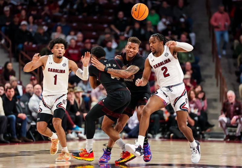 Jan 14, 2023; Columbia, South Carolina, USA; South Carolina Gamecocks guard Jacobi Wright (1) guard Chico Carter Jr. (2) battle for a loose ball against Texas A&M Aggies guard Wade Taylor IV (4) guard Dexter Dennis (0)  in the first half at Colonial Life Arena. Mandatory Credit: Jeff Blake-USA TODAY Sports