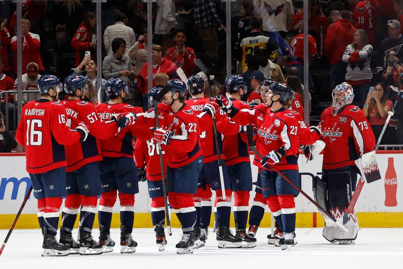 Oct 31, 2024; Washington, District of Columbia, USA; Washington Capitals players celebrate after their game against the Montreal Canadiens at Capital One Arena. Mandatory Credit: Geoff Burke-Imagn Images