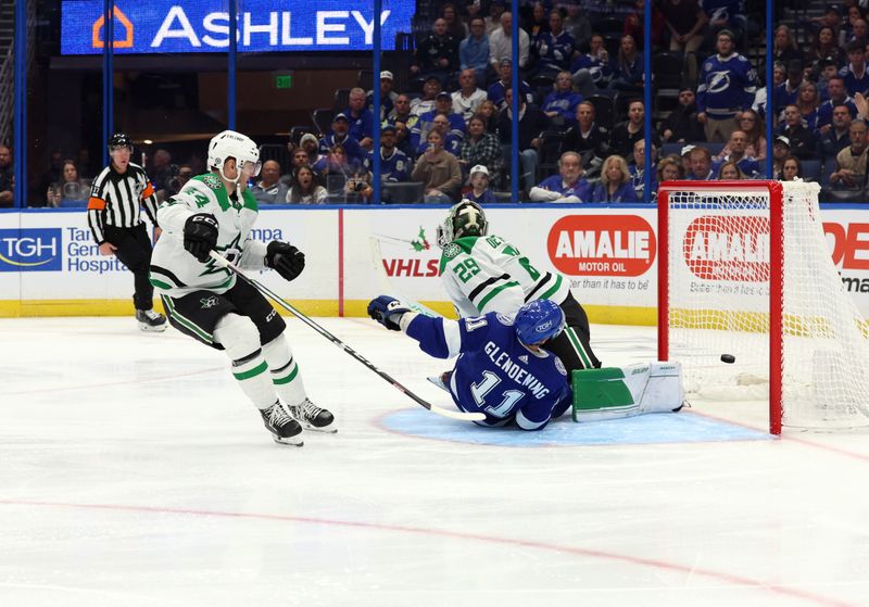 Dec 4, 2023; Tampa, Florida, USA; Tampa Bay Lightning center Luke Glendening (11) scores a goal past Dallas Stars defenseman Joel Hanley (44) on goaltender Jake Oettinger (29)  during the third period at Amalie Arena. Mandatory Credit: Kim Klement Neitzel-USA TODAY Sports