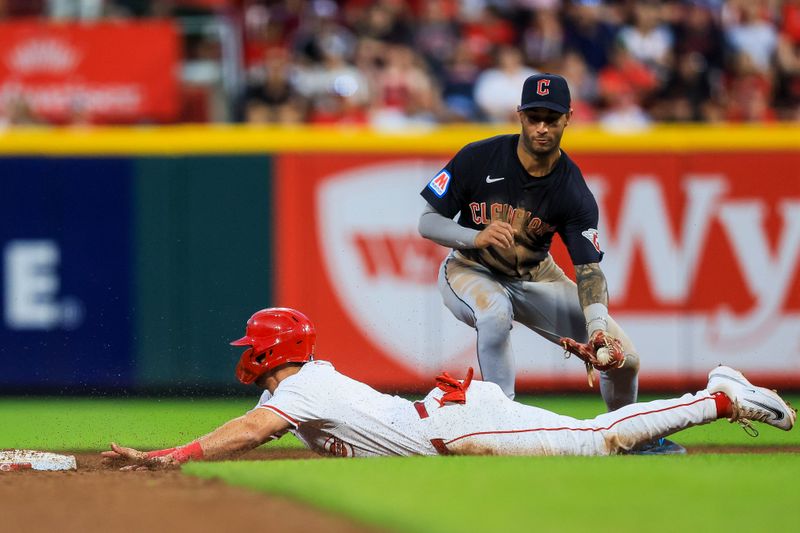 Jun 12, 2024; Cincinnati, Ohio, USA; Cincinnati Reds first baseman Spencer Steer (7) steals second against Cleveland Guardians shortstop Brayan Rocchio (4) in the sixth inning at Great American Ball Park. Mandatory Credit: Katie Stratman-USA TODAY Sports