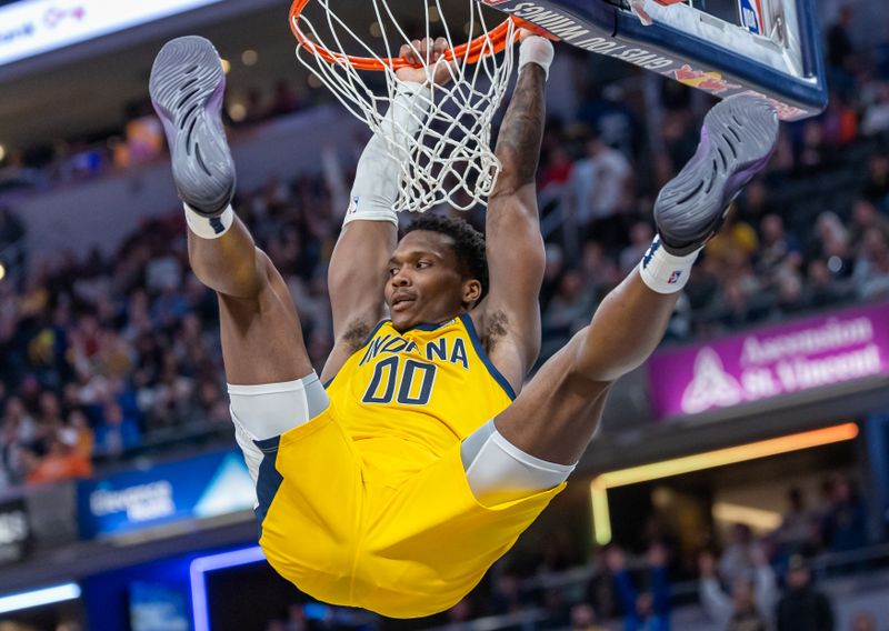 INDIANAPOLIS, INDIANA - NOVEMBER 10: Bennedict Mathurin #00 of the Indiana Pacers hangs from the rim after a dunk during the second half against the New York Knicks at Gainbridge Fieldhouse on November 10, 2024 in Indianapolis, Indiana. NOTE TO USER: User expressly acknowledges and agrees that, by downloading and or using this photograph, User is consenting to the terms and conditions of the Getty Images License Agreement. (Photo by Michael Hickey/Getty Images)