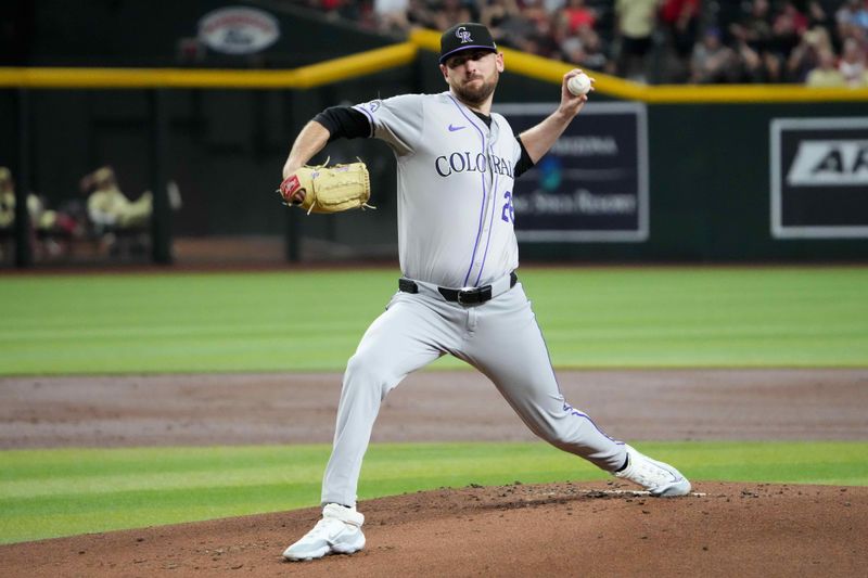 Aug 13, 2024; Phoenix, Arizona, USA; Colorado Rockies pitcher Austin Gomber (26) pitches against the Arizona Diamondbacks during the first inning at Chase Field. Mandatory Credit: Joe Camporeale-USA TODAY Sports