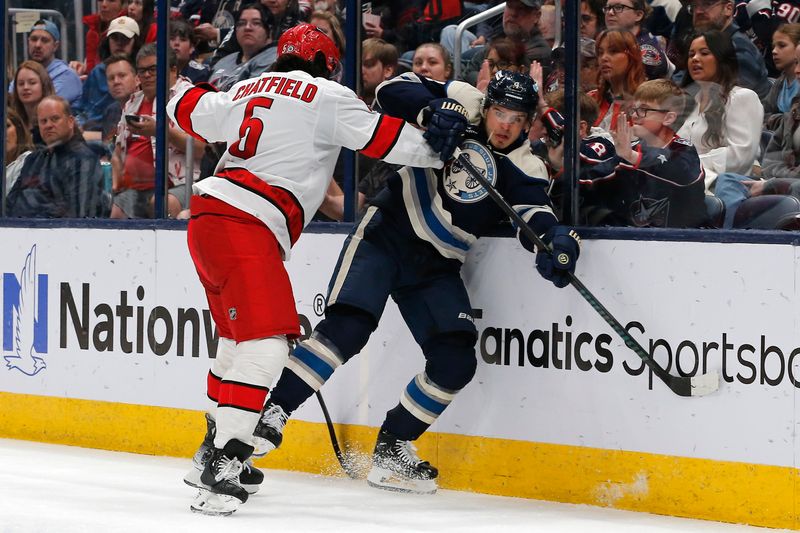 Apr 16, 2024; Columbus, Ohio, USA; Carolina Hurricanes defenseman Jalen Chatfield (5) checks Columbus Blue Jackets forward Cole Sillinger (4) during the second period at Nationwide Arena. Mandatory Credit: Russell LaBounty-USA TODAY Sports