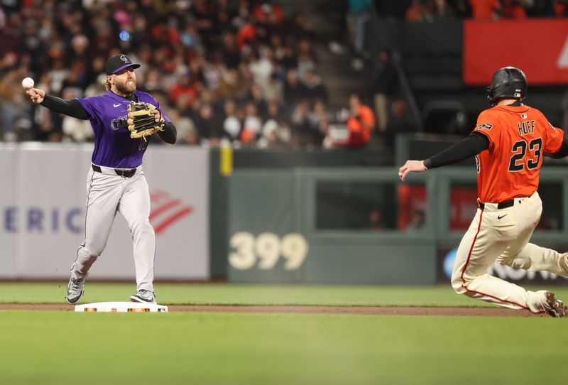 May 2, 2025; San Francisco, California, USA; Colorado Rockies second baseman Owen Miller (11) throws the ball against San Francisco Giants catcher Sam Huff (23) during the fourth inning at Oracle Park. Mandatory Credit: Kelley L Cox-Imagn Images