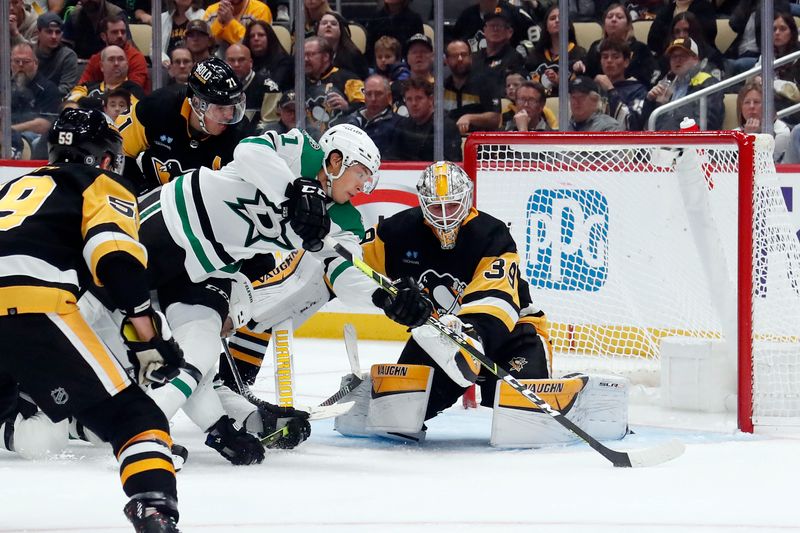 Oct 24, 2023; Pittsburgh, Pennsylvania, USA; Dallas Stars left wing Jason Robertson (21) shoots and scores a goal against Pittsburgh Penguins goaltender Alex Nedeljkovic (39) during the second period at PPG Paints Arena. Mandatory Credit: Charles LeClaire-USA TODAY Sports