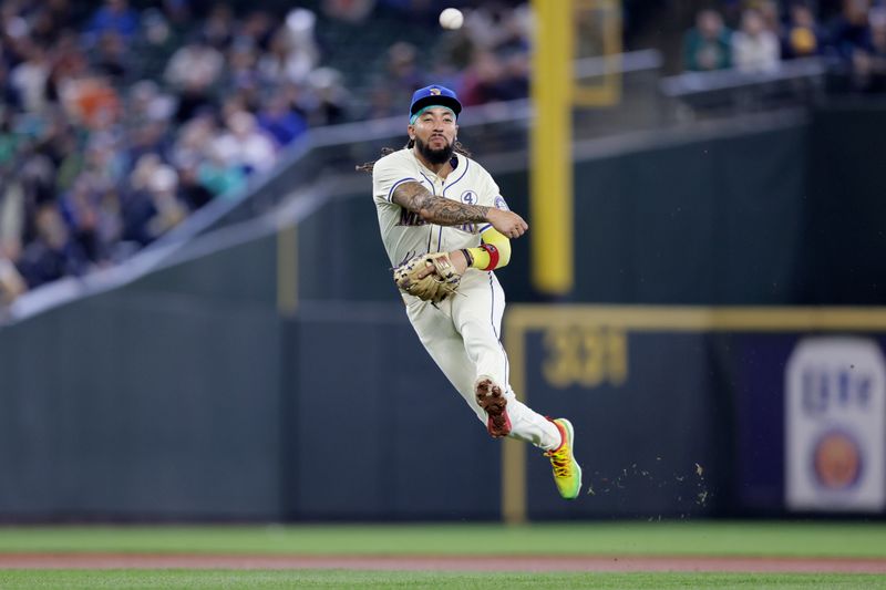 Jun 2, 2024; Seattle, Washington, USA; Seattle Mariners shortstop J.P. Crawford (3) throws to first base against the Los Angeles Angels during the seventh inning at T-Mobile Park. Mandatory Credit: John Froschauer-USA TODAY Sports