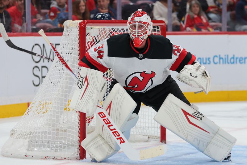 Nov 20, 2025; Sunrise, Florida, USA; New Jersey Devils goaltender Jake Allen (34) defends his net against the Florida Panthers during the second period at Amerant Bank Arena. Mandatory Credit: Sam Navarro-Imagn Images