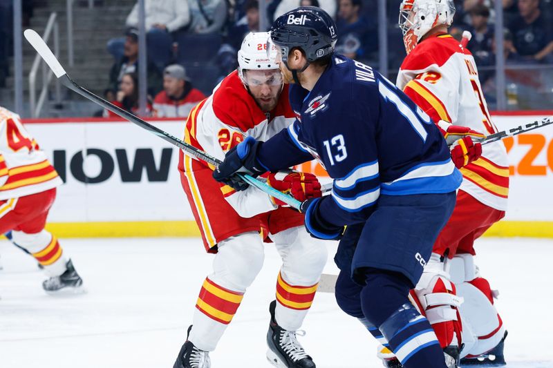 Oct 2, 2024; Winnipeg, Manitoba, CAN;  Calgary Flames defenseman Jared Tinordi (26) jostles for position with Winnipeg Jets forward Gabriel Vilardi (13) during the second period at Canada Life Centre. Mandatory Credit: Terrence Lee-Imagn Images