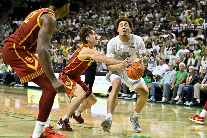 Mar 1, 2025; Eugene, Oregon, USA; Oregon Ducks guard Jadrian Tracey (2) drives to the basket against defense by USC Trojans guard Clark Slajchert (32) during the first half at Matthew Knight Arena. Mandatory Credit: Craig Strobeck-Imagn Images