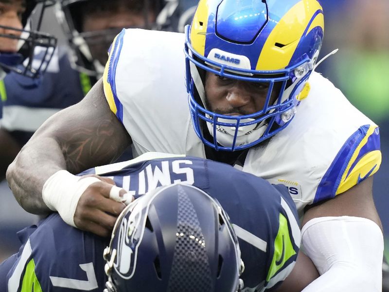 Los Angeles Rams linebacker Jared Verse, top, sacks Seattle Seahawks quarterback Geno Smith during the first half of an NFL football game in Seattle, Sunday, Nov. 3, 2024. (AP Photo/Stephen Brashear)