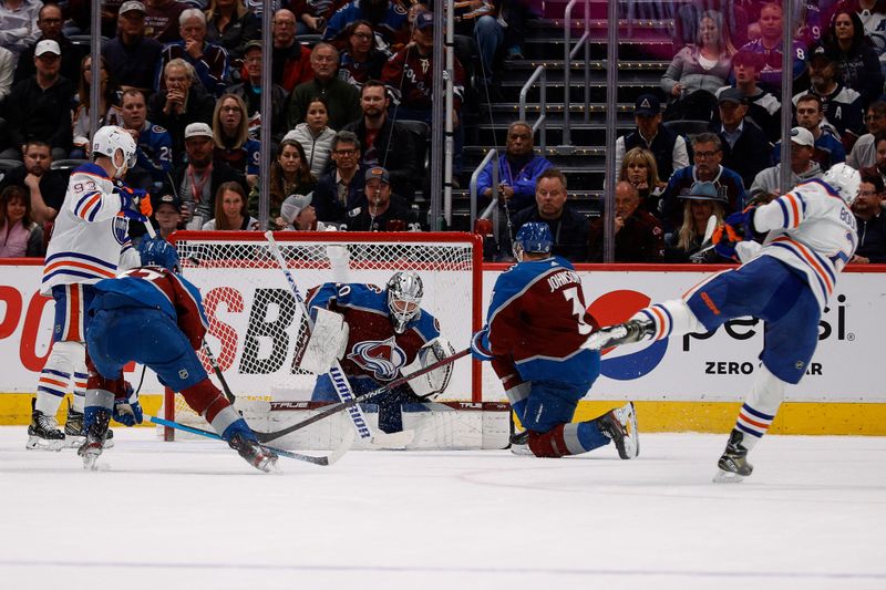 Apr 11, 2023; Denver, Colorado, USA; Edmonton Oilers defenseman Evan Bouchard (2) scores on a shot against Colorado Avalanche goaltender Alexandar Georgiev (40) as defenseman Jack Johnson (3) and left wing J.T. Compher (37) and center Ryan Nugent-Hopkins (93) look on in overtime at Ball Arena. Mandatory Credit: Isaiah J. Downing-USA TODAY Sports