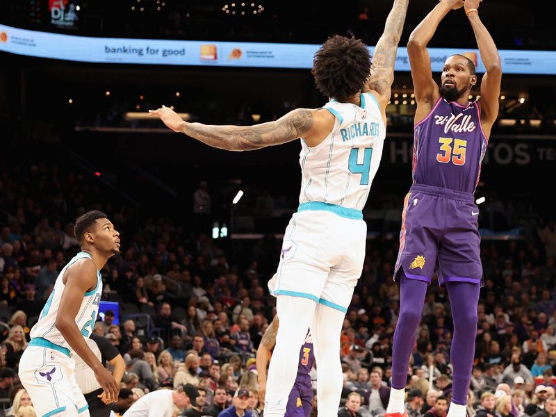 PHOENIX, ARIZONA - DECEMBER 29:  Kevin Durant #35 of the Phoenix Suns attempts a three-point shot over Nick Richards #4 of the Charlotte Hornets during the first half of the NBA game at Footprint Center on December 29, 2023 in Phoenix, Arizona. The Suns defeated the Hornets 133-119. NOTE TO USER: User expressly acknowledges and agrees that, by downloading and or using this photograph, User is consenting to the terms and conditions of the Getty Images License Agreement.  (Photo by Christian Petersen/Getty Images)