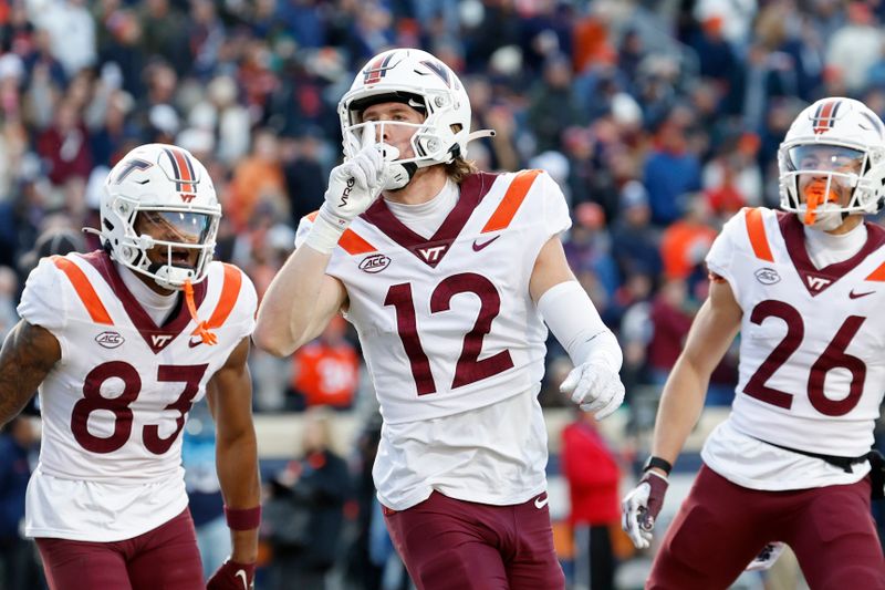 Nov 25, 2023; Charlottesville, Virginia, USA; Virginia Tech Hokies wide receiver Stephen Gosnell (12) celebrates after scoring a touchdown against the Virginia Cavaliers during the first quarter at Scott Stadium. Mandatory Credit: Geoff Burke-USA TODAY Sports