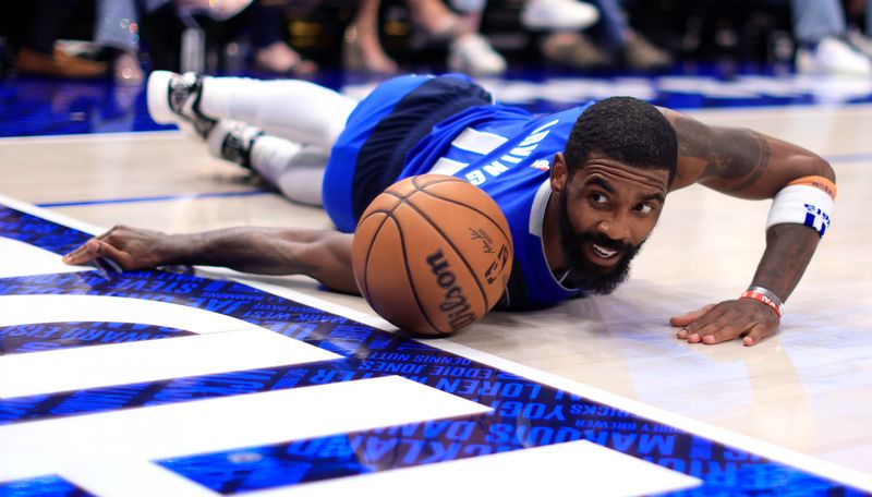 DALLAS, TX - APRIL 04: Kyrie Irving #11 of the Dallas Mavericks dives for a loose ball against the Atlanta Hawks in the second half at American Airlines Center on April 4, 2024 in Dallas, Texas. NOTE TO USER: User expressly acknowledges and agrees that, by downloading and or using this photograph, User is consenting to the terms and conditions of the Getty Images License Agreement. (Photo by Ron Jenkins/Getty Images)