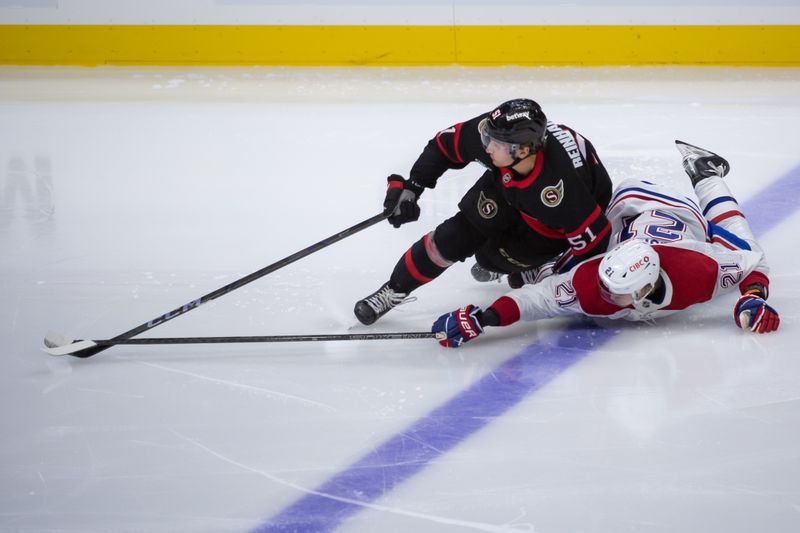 Oct 5, 2024; Ottawa, Ontario, CAN; Ottawa Senators left wing Cole Reinhardt (51) and Montreal Canadiens defenseman Kaiden Ghule (21) battle for the puck in the period at the Canadian Tire Centre. Mandatory Credit: Marc DesRosiers-Imagn Images