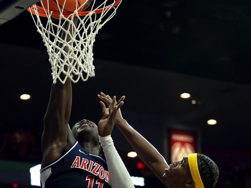 Jan 17, 2024; Tucson, Arizona, USA; Arizona Wildcats center Oumar Ballo (11) shoots a basket against USC Trojans forward Vincent Iwuchukwu (3) during the second half at McKale Center. Mandatory Credit: Zachary BonDurant-USA TODAY Sports