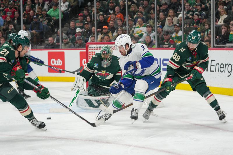 Feb 19, 2024; Saint Paul, Minnesota, USA; Vancouver Canucks right wing Conor Garland (8) is checked by Minnesota Wild center Frederick Gaudreau (89) in front of goaltender Marc-Andre Fleury (29) in the third period at Xcel Energy Center. Mandatory Credit: Matt Blewett-USA TODAY Sports